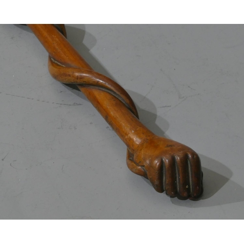 665 - A 19th Century carved wooden walking stick with hand finial clutching entwined end coiled around who... 