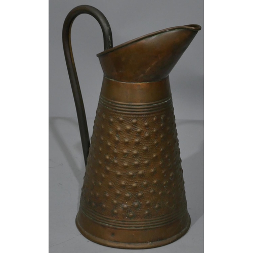 667 - R Perry, Wolverhampton copper round jug with embossed studded decoration, 31cm high.