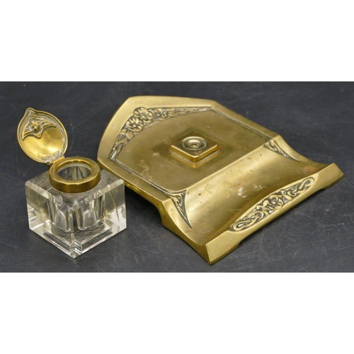 671 - An Art Nouveau style brass ink stand with square cut glass bottle and hinged lid, embossed floral an... 