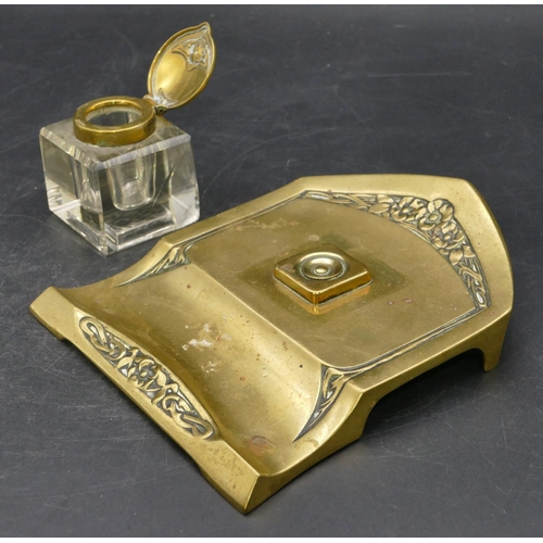 671 - An Art Nouveau style brass ink stand with square cut glass bottle and hinged lid, embossed floral an... 