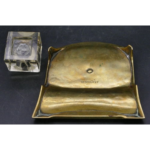 671 - An Art Nouveau style brass ink stand with square cut glass bottle and hinged lid, embossed floral an... 