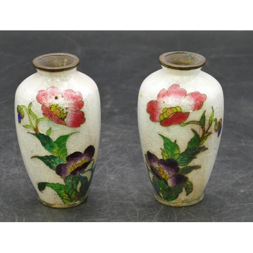 674 - A pair of Oriental small enamelled round bulbous thin necked vases on white ground with multi-colour... 