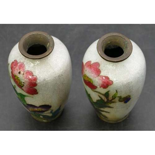 674 - A pair of Oriental small enamelled round bulbous thin necked vases on white ground with multi-colour... 