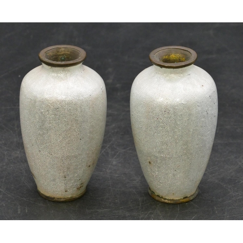 674 - A pair of Oriental small enamelled round bulbous thin necked vases on white ground with multi-colour... 