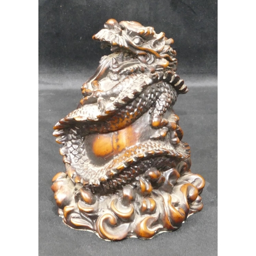 697 - A resin model of a Chinese dragon wrapped around a ball, 15cm high.