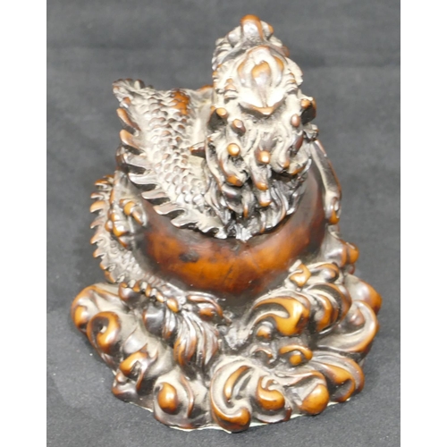 697 - A resin model of a Chinese dragon wrapped around a ball, 15cm high.