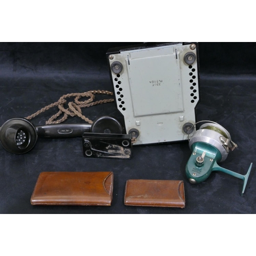 701 - A black Bakelite telephone handset, stamped 164 64, an Aldora fishing reel and 2 leather cigar cases... 