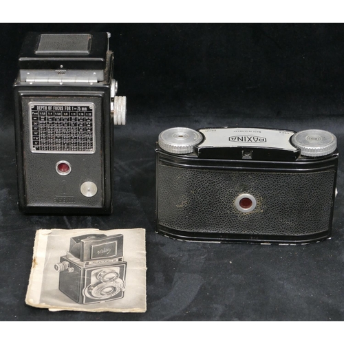 702 - A Reflekta II Welta camera in leather case and a Paxina camera (2)