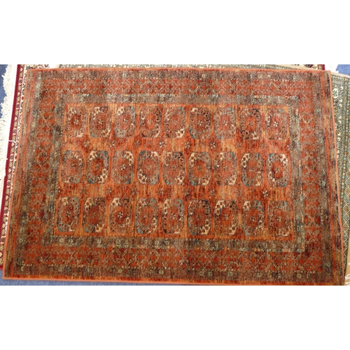 709 - A modern Persian style rug on red ground with 3 x 9 centre medallions, 179cm x 122cm