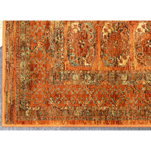 709 - A modern Persian style rug on red ground with 3 x 9 centre medallions, 179cm x 122cm