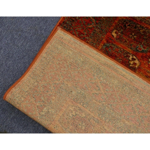 709 - A modern Persian style rug on red ground with 3 x 9 centre medallions, 179cm x 122cm