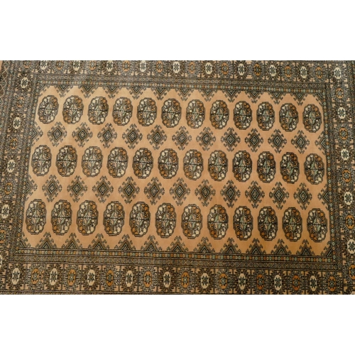 710 - A modern Eastern knotted rug on cream ground with 3 x 12 centre medallions, 181cm x 127cm