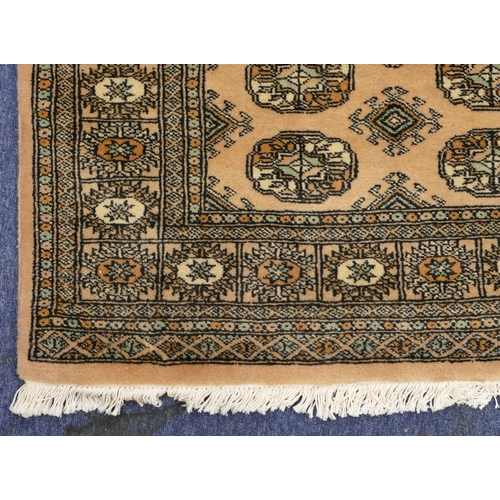 710 - A modern Eastern knotted rug on cream ground with 3 x 12 centre medallions, 181cm x 127cm