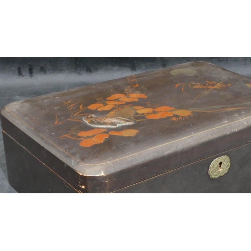 713 - An Oriental lacquered rectangular shaped box on black ground with raised bird, gilt and leaf decorat... 