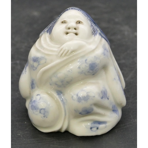 72 - An Oriental Herado china figure of a seated lady on blue and white ground, 6.2cm high.