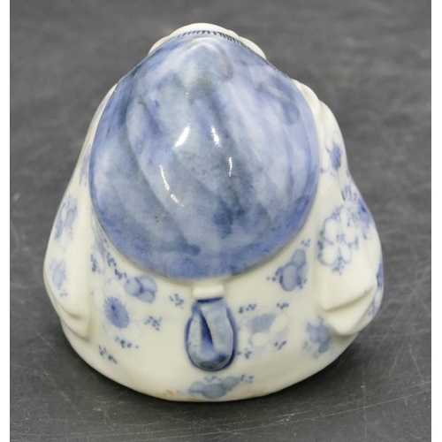 72 - An Oriental Herado china figure of a seated lady on blue and white ground, 6.2cm high.