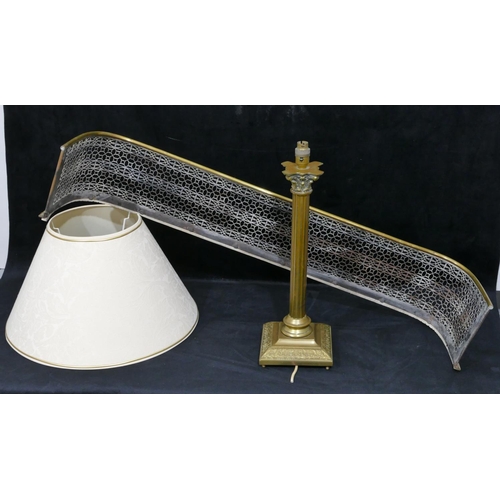 723 - A brass and silvered metal fire fender with pierced decoration, 101.5cm long, a brass Corinthian col... 