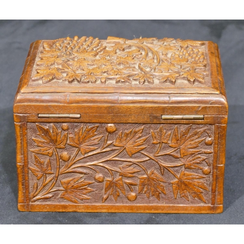 741 - A carved wooden rectangular shaped box with raised grape and vine decoration, hinged lid, 15cm wide