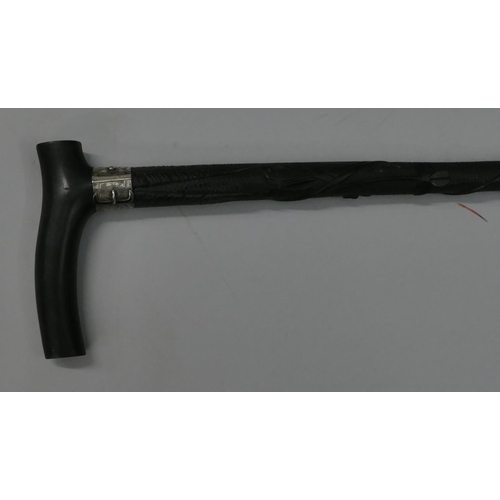 748 - An ebony walking cane with a Birmingham silver buckle neck, raised carved twist leaf decoration, 92.... 