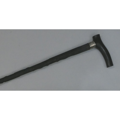 748 - An ebony walking cane with a Birmingham silver buckle neck, raised carved twist leaf decoration, 92.... 