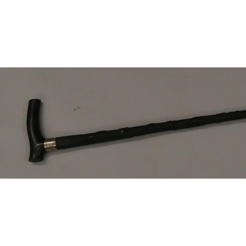 748 - An ebony walking cane with a Birmingham silver buckle neck, raised carved twist leaf decoration, 92.... 