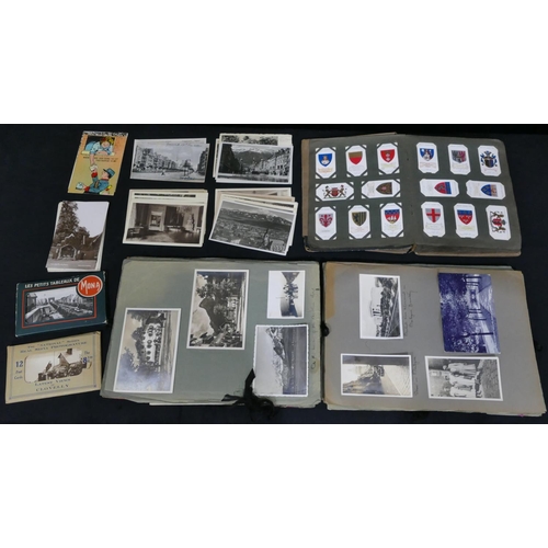 750 - A postcard and photograph album, a small quantity of loose postcards and an album of cigarette cards