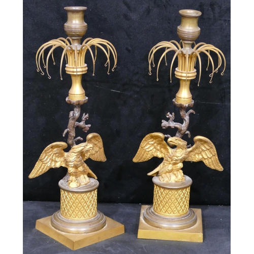 758 - A pair of 19th Century gilt metal and bronze Lustre candlesticks, with eagle motifs and standing upo... 