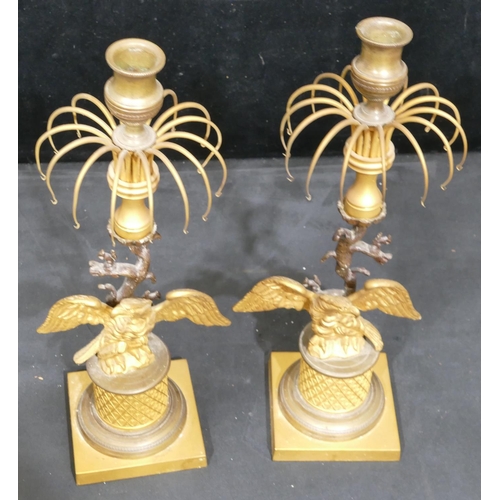 758 - A pair of 19th Century gilt metal and bronze Lustre candlesticks, with eagle motifs and standing upo... 