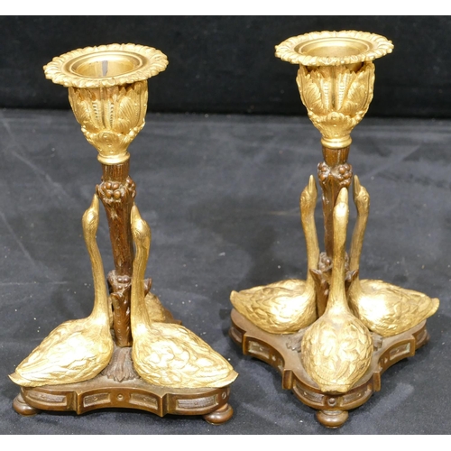 759 - A pair of bronze and ormolu candlesticks in the form of 3 swans on tripod base with bun feet, 17cm h... 