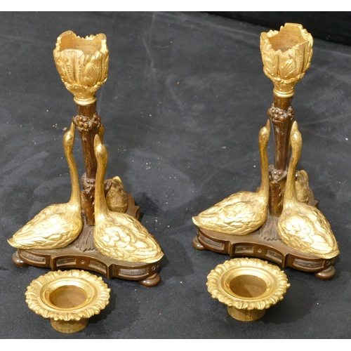 759 - A pair of bronze and ormolu candlesticks in the form of 3 swans on tripod base with bun feet, 17cm h... 