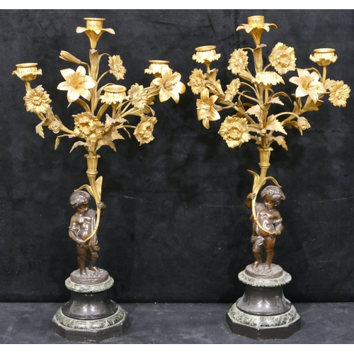 760 - A pair of 19th Century bronze and ormolu candelabras in the form of cupids with allover raised flora... 