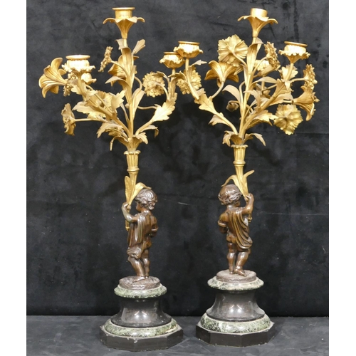 760 - A pair of 19th Century bronze and ormolu candelabras in the form of cupids with allover raised flora... 