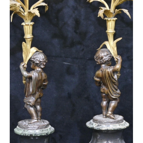 760 - A pair of 19th Century bronze and ormolu candelabras in the form of cupids with allover raised flora... 