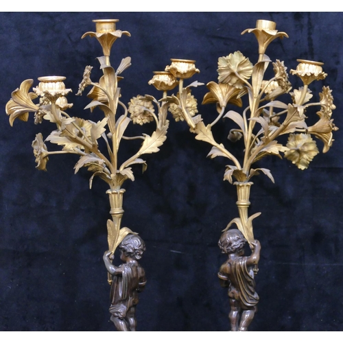 760 - A pair of 19th Century bronze and ormolu candelabras in the form of cupids with allover raised flora... 