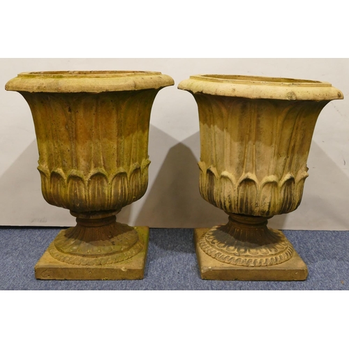 761 - A pair of Doulton & Co, Lambeth earthenware garden octagonal urns with raised leaf decoration on squ... 