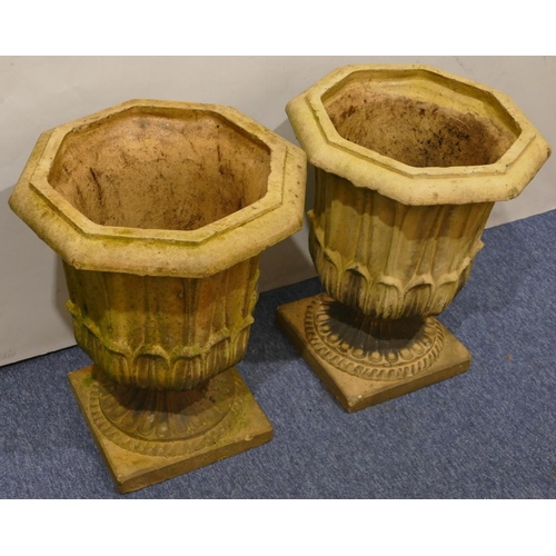 761 - A pair of Doulton & Co, Lambeth earthenware garden octagonal urns with raised leaf decoration on squ... 