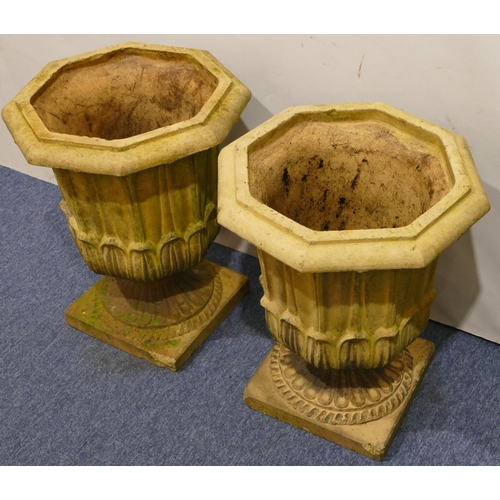 761 - A pair of Doulton & Co, Lambeth earthenware garden octagonal urns with raised leaf decoration on squ... 