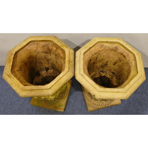 761 - A pair of Doulton & Co, Lambeth earthenware garden octagonal urns with raised leaf decoration on squ... 