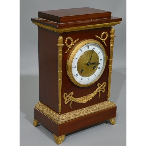 766 - A French Empire 8-day half hour striking mahogany mantel clock with allover raised gilt, metal, swag... 