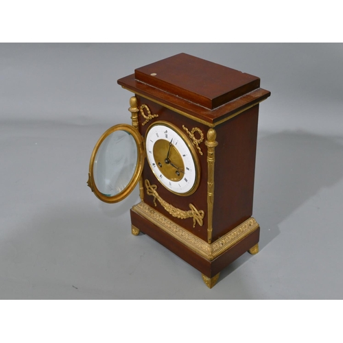 766 - A French Empire 8-day half hour striking mahogany mantel clock with allover raised gilt, metal, swag... 