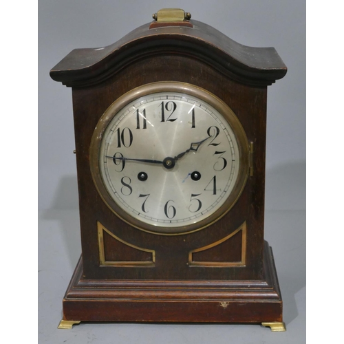 771 - A Junghans oak 8-day striking arch topped mantel clock with brass carrying handle and various mounts... 