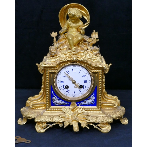 781 - A Vincenti ormolu 8-day striking mantel clock with cupid motif to top holding 2 fish seated in a she... 