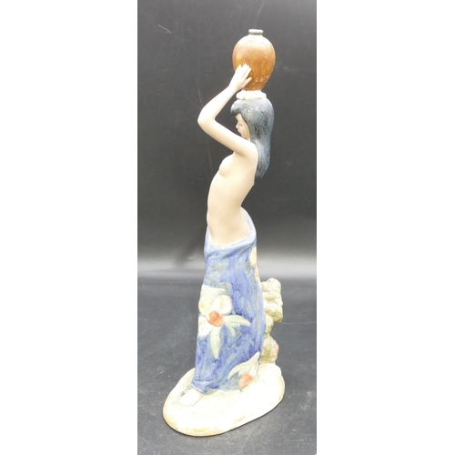 79 - A Nadal glazed earthenware figure of half naked lady holding a jug on her head, 39cm high.