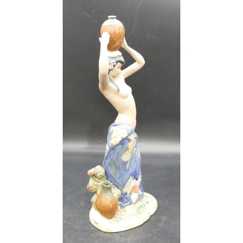 79 - A Nadal glazed earthenware figure of half naked lady holding a jug on her head, 39cm high.