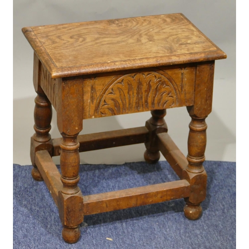 791 - An oak rectangular shaped stool with hinged seat, carved frieze on round turned legs with stretchers... 