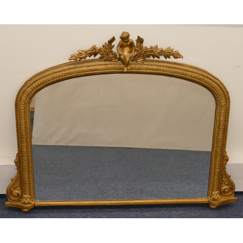 796 - A gilt hanging arched topped over mantel with raised figure, leaf and berry decoration, scroll sides... 