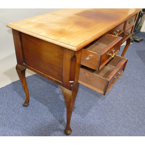 802 - A mahogany knee-hole writing table with single drawer flanked by 4 shorter drawers with drop brass h... 