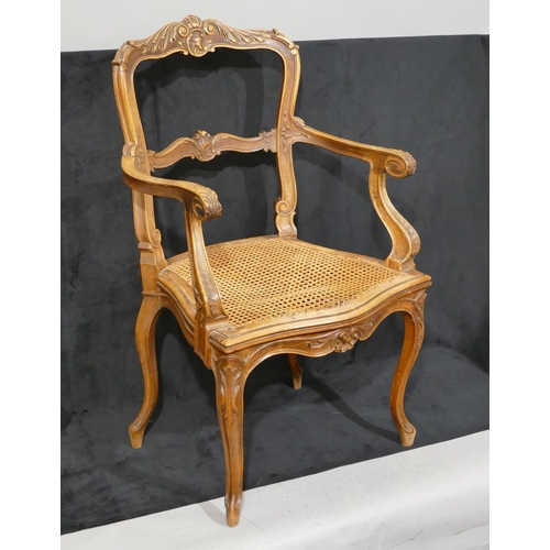 811 - A Continental walnut armchair with bar back, raised carved shell, floral and swirl decoration, Berge... 