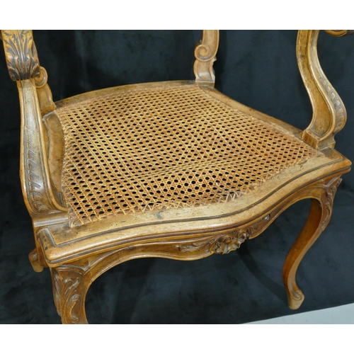 811 - A Continental walnut armchair with bar back, raised carved shell, floral and swirl decoration, Berge... 