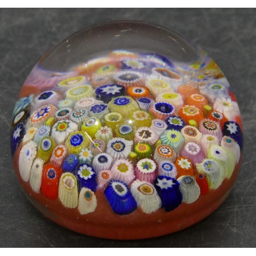 91 - A glass bulbous shaped millefiori paperweight with multi-coloured inner decoration, 6.5cm diameter.